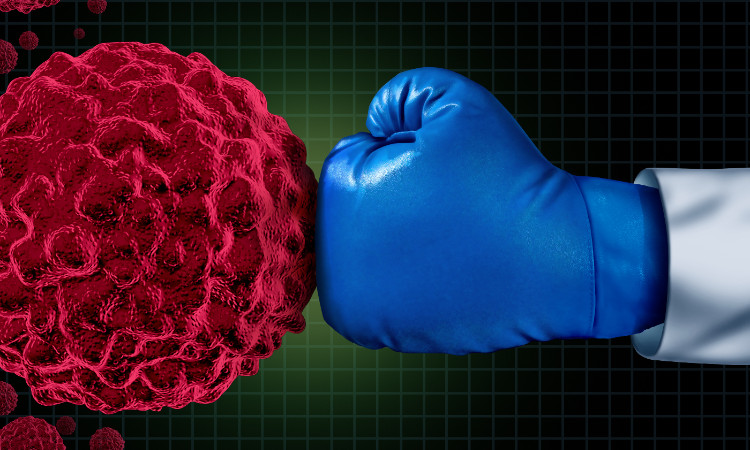 ein Schlag mit einem blauen Boxhandschuh auf eine Tumorzelle