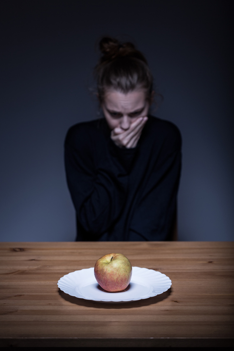 Frau verweigert Essen, es liegt ein Apfel auf dem Teller, ekelhaft